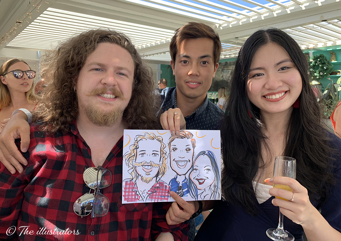 Happy company employees holding a caricature drawing in Sydney