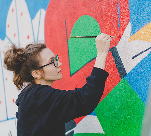 A girl painting a mural